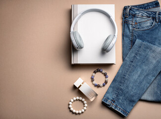 Photography of woman's accessories, jeans, earphone, book, bracelet, perfume