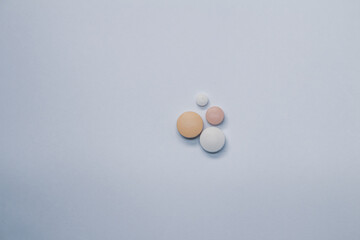 four pills on a white background Free space to write. Concept of self-medication