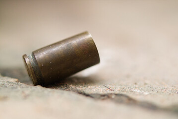 Bullet on ground for inspection of crime evidence.