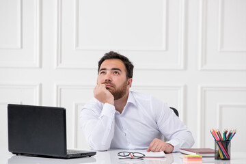 Naklejka premium ADHD brunette young office worker at work behind the desk with the computer dreaming of something