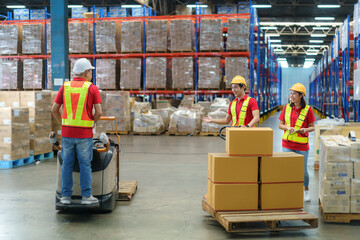 Asian man Warehouse worker talking with his foreman during unloading pallet shipment goods into a truck container, warehouse industry freight, logistics and transport.