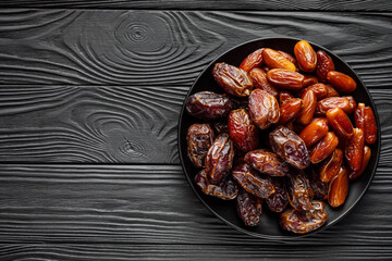 juicy royal dates on a black wooden rustic background