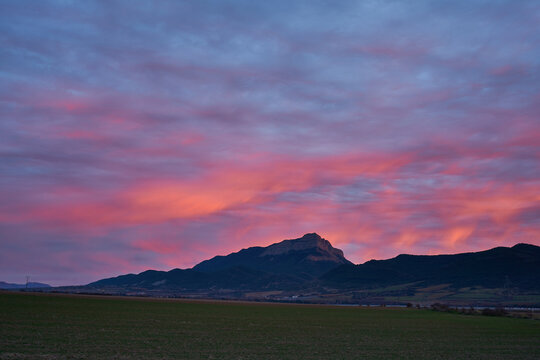 Beautiful sunset on the Aragon river valley with a view of Pe&ntilde;a Oroel, the iconic mountain near Jaca