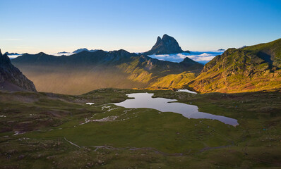 Aerial image of the Anayet lake with the pic of Midi d'Ossau in the background and clouds coming...