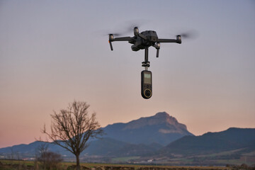 View of a drone holding a 360 video camera, flying close to the Oroel mountain in spanish Pyrenees
