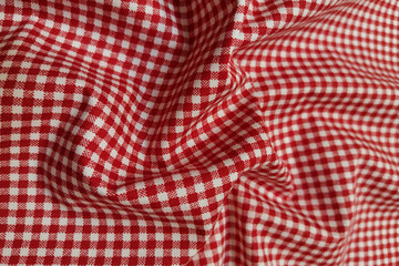 Red plaid fabric. Crumpled or wavy fabric texture background. Abstract linen cloth soft waves. Natural yarn. Smooth elegant luxury cloth texture. Concept for banner or advertisement
