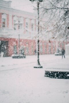 Vertical shot of the man walking down the snowy street of Brcko District. Bosnia and Herzegovina.