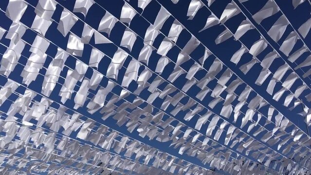 White rectangular flags flying in the light summer breeze in the old town of Jaffa in Tel Aviv in Israel