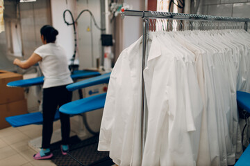 Dry cleaning shirts clothes. Clean cloth chemical process. Laundry industrial dry-cleaning.