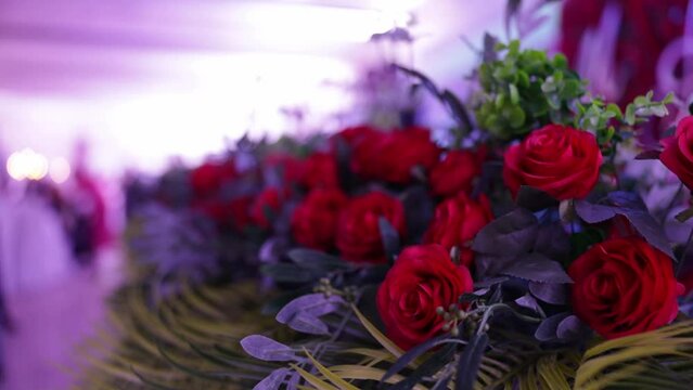 Closeup of red roses and green leaves as a decoration at an event