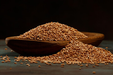 Still life of the wheat harvest. Grains of ripe wheat in in a rustic bowl . Selective focus. 