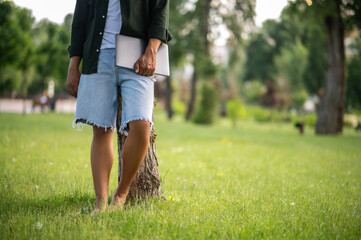 Man standing near tree without face