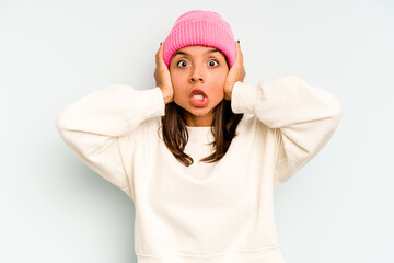 Young hispanic woman isolated on blue background having a neck pain due to stress, massaging and touching it with hand.