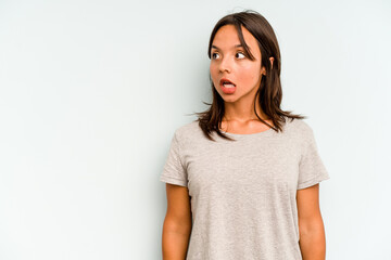 Young hispanic woman isolated on blue background raising both thumbs up, smiling and confident.