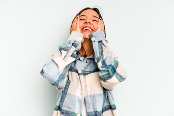 Young hispanic woman isolated on blue background doing a denial gesture