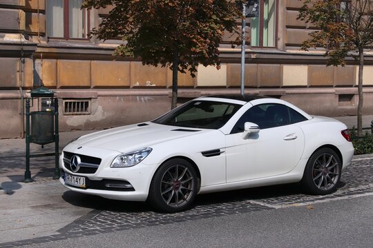 KRAKOW, POLAND - AUGUST 28, 2018: White Mercedes-Benz SLK sports coupe car parked in Krakow. Poland has 33 million registered motor vehicles.