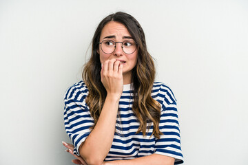 Young caucasian woman isolated on white background biting fingernails, nervous and very anxious.