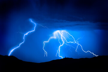 Lightning Bolts on Mountain with Radio Tower Blue Sky Silhouette