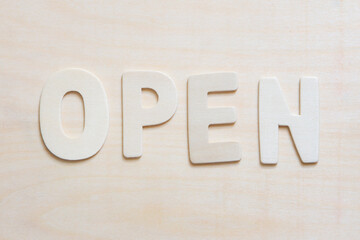 wood letters with message open