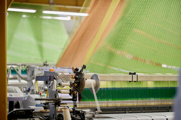 Industrial textile production line. Weaving looms in a textile factory