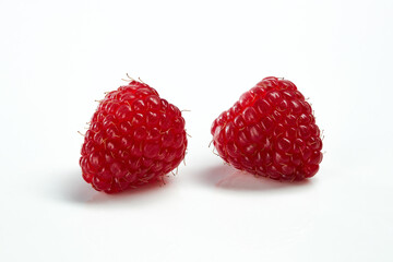 Two raspberries on white background.