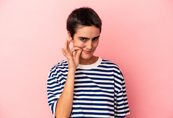 Young caucasian woman isolated on blue background with fingers on lips keeping a secret.