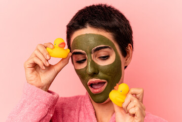 Young caucasian woman wearing a face mask isolated on pink background