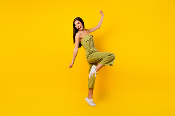 Fototapeta na wymiar Full size photo of lovely overjoyed filipino lady chilling dancing spend pastime isolated on yellow color background