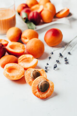 close-up on ripe apricots and apricot smoothie on white background