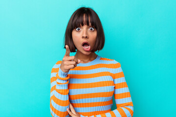 Young mixed race woman isolated on blue background having an idea, inspiration concept.