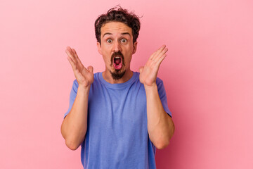 Young caucasian man isolated on pink background surprised and shocked.