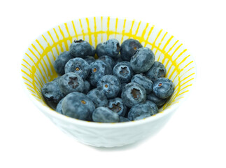Blueberry in white and yellow bowl antioxidant organic superfood