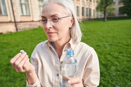 Kind Mature Woman Going To Take Medicine