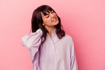 Young caucasian woman isolated on pink background having a neck pain due to stress, massaging and touching it with hand.