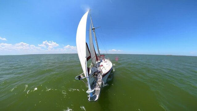 Cutter rig sailboat close hauled under full sail speeding across the ocean