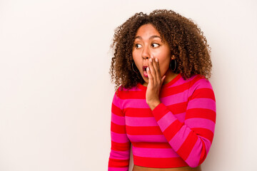 Fototapeta na wymiar Young African American woman isolated on white background being shocked because of something she has seen.