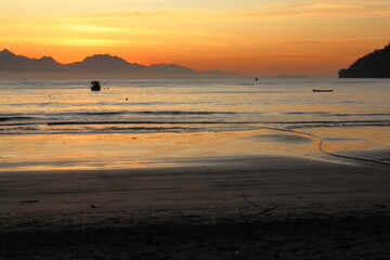 Golden winter sunrise at Itagua beach, Ubatuba, Brazil