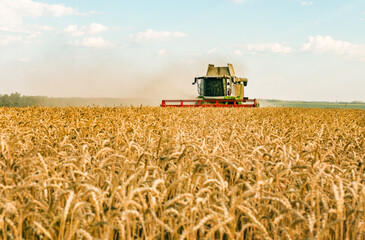 Combine in the field harvests wheat. Export and import of wheat. World food crisis.