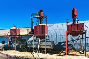 bunker silos for loading sawdust next to the hangar, which houses the woodworking industry