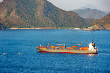 Cargo ship loaded with containers sailing in the sea waters of Guanabara Bay in Rio de Janeiro