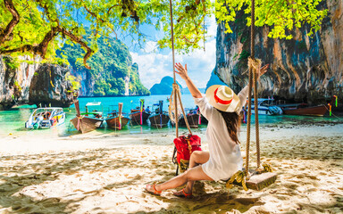 Happy traveler woman on swing joy nature scenic landscape Lao Lading beach island Krabi, Famous...