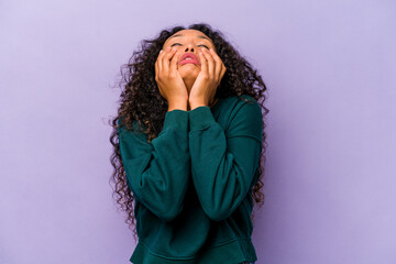 Young hispanic woman isolated on purple background whining and crying disconsolately.