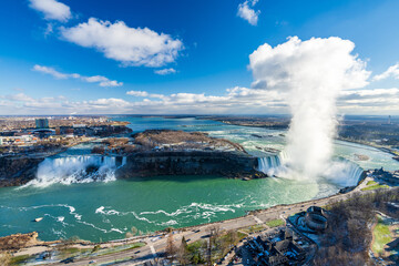 Overlooking the Niagara Falls ( American Falls and Horseshoe Falls ) in a sunny day.