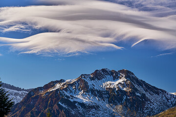 Stunning clouds over the summit of the acue on the Aspe valley on french Pyrenees