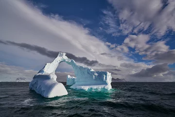 Gordijnen Antartic sea iceber with arch shape © Pyrenees Photo