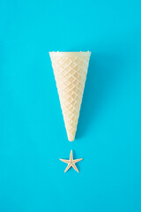 Minimal concept ice cream and starfish on blue background. Flat lay.