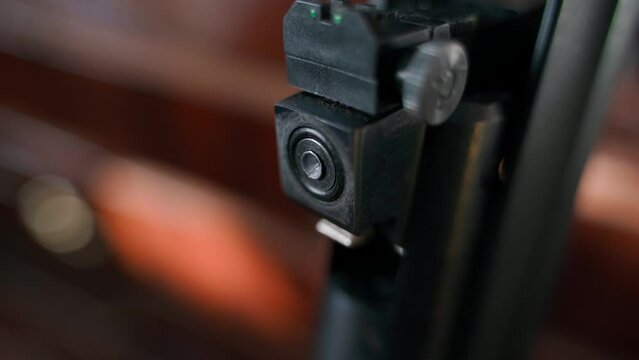 Hand inserting a diabolo bullet into the bullet chamber in an air rifle close-up