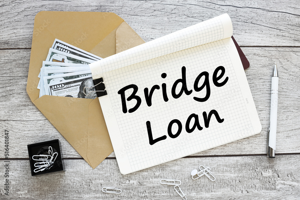 Poster bridge loan. text on an open notepad. notebook next to money in an envelope
