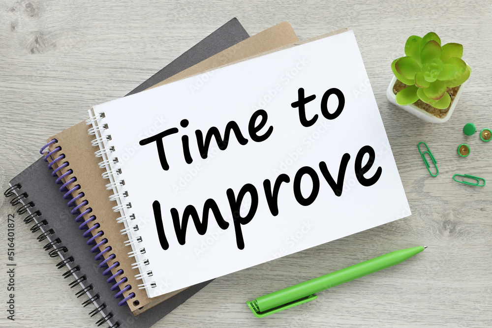 Poster time to improve written text in notepad with pen and glass on gray background. business style
