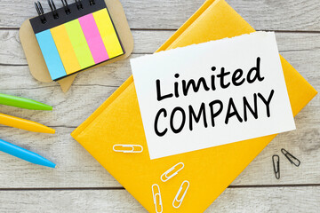 Limited company words concept. grey background. yellow notepad